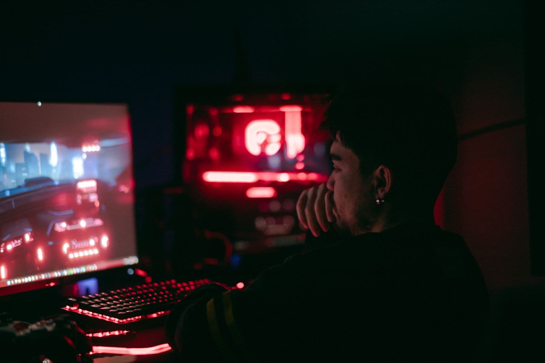 Player immersed in a dark gaming setup