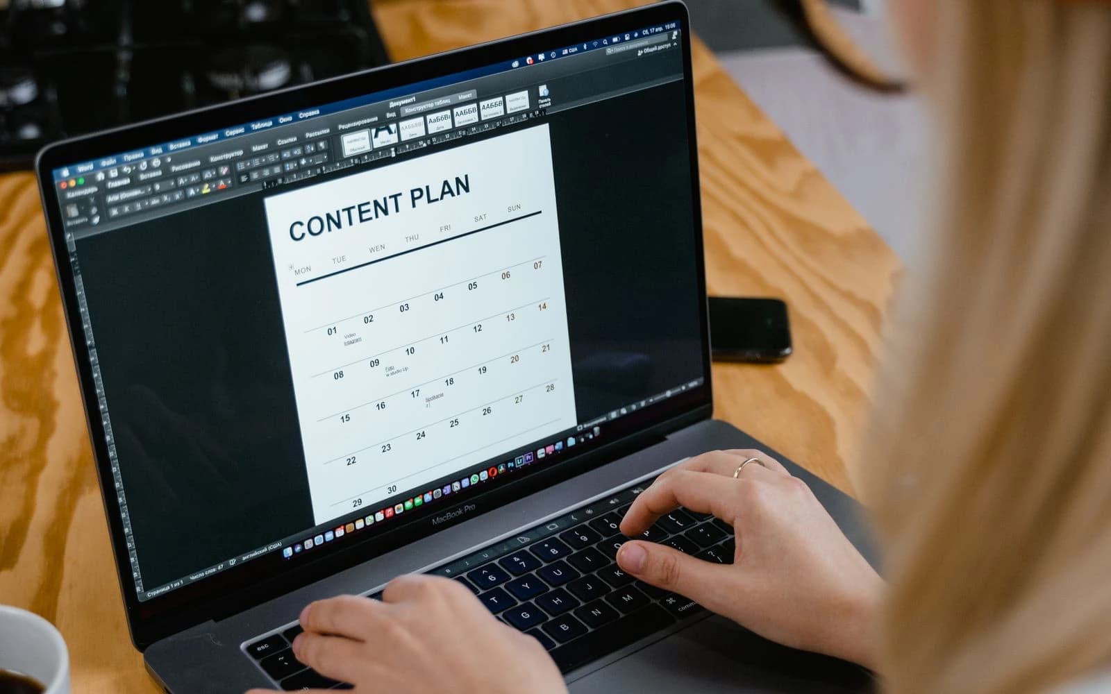 Content planner organising a schedule on a laptop