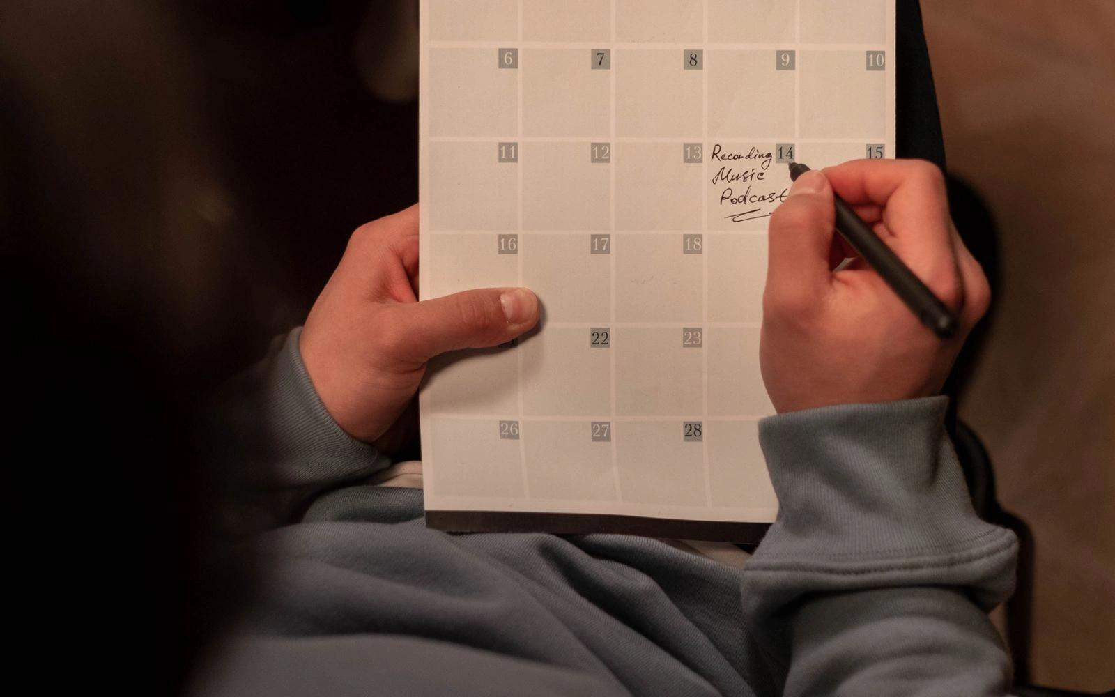 Hands organising ideas in a content planner